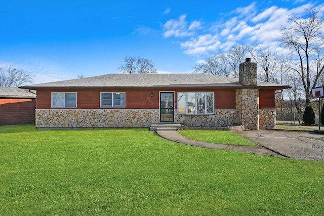 view of front facade featuring a front yard, stone siding, and a chimney