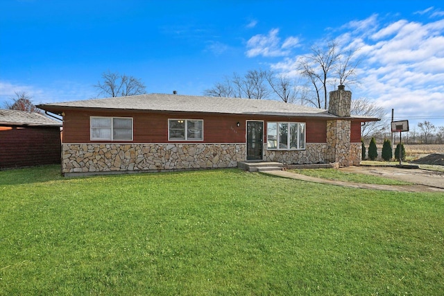 single story home with stone siding, a chimney, and a front lawn