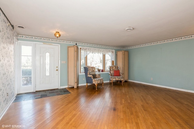 foyer entrance featuring baseboards and hardwood / wood-style floors