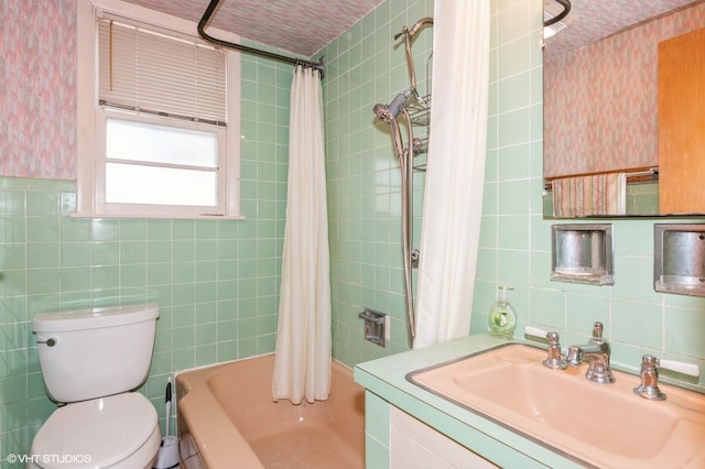 bathroom with wallpapered walls, tile walls, shower / bath combination with curtain, and toilet