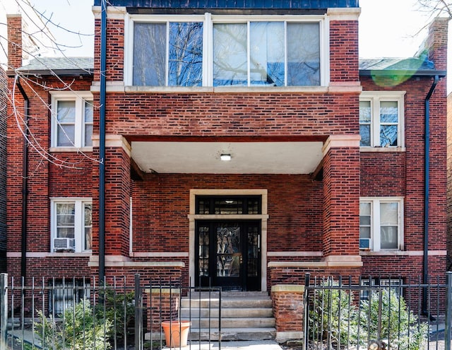 view of front of home with brick siding and a fenced front yard