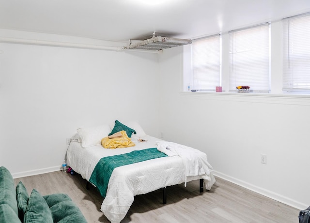 bedroom with wood finished floors and baseboards