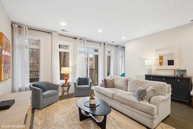 living area featuring wood finished floors, visible vents, and recessed lighting