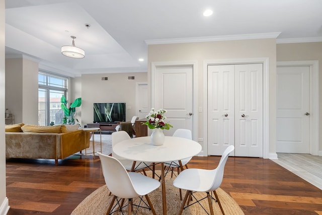 dining room with baseboards, ornamental molding, wood finished floors, and recessed lighting