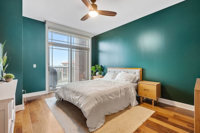 bedroom featuring ceiling fan, access to outside, wood finished floors, and baseboards