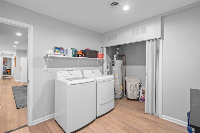 washroom featuring gas water heater, visible vents, and laundry area