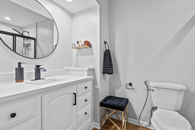 bathroom featuring recessed lighting, baseboards, vanity, and toilet