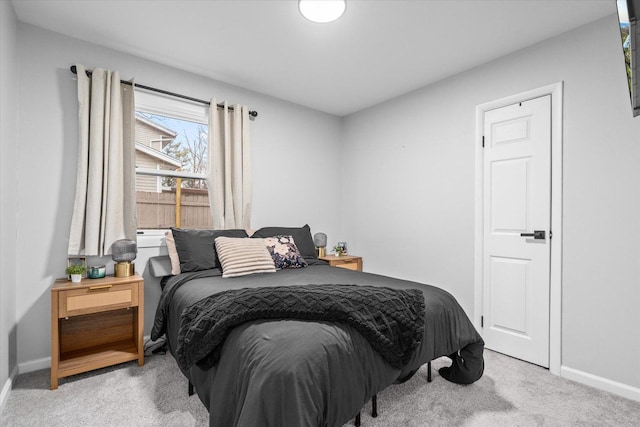 carpeted bedroom featuring baseboards