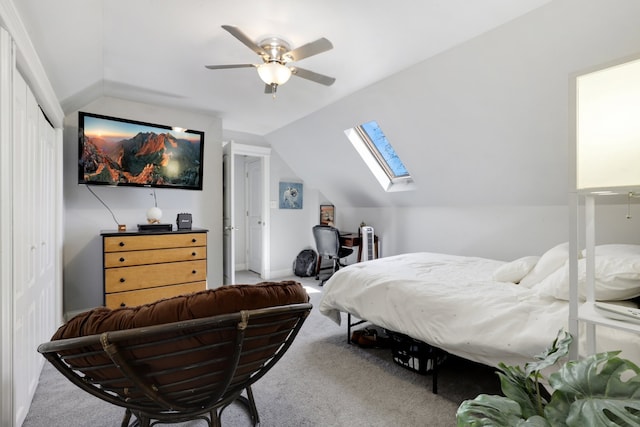 bedroom with a closet, carpet, a ceiling fan, and vaulted ceiling