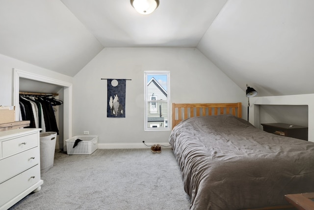 bedroom with baseboards, light carpet, and vaulted ceiling