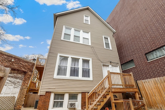 back of property featuring stairway and fence