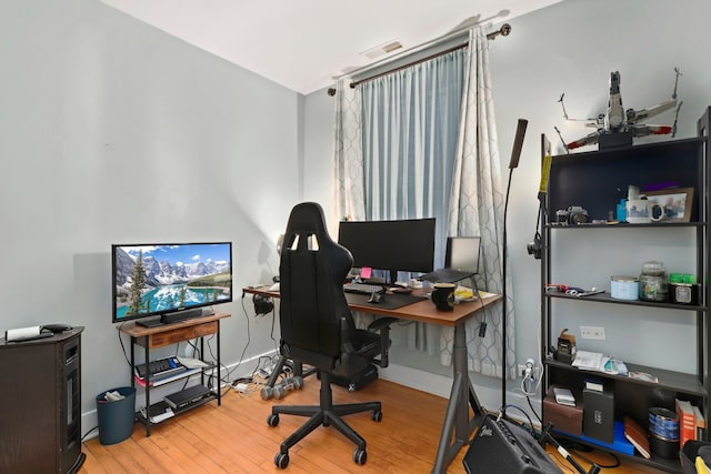 office area featuring visible vents, wood finished floors, and baseboards