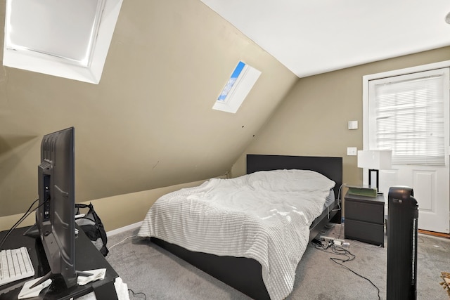 carpeted bedroom with lofted ceiling with skylight and baseboards