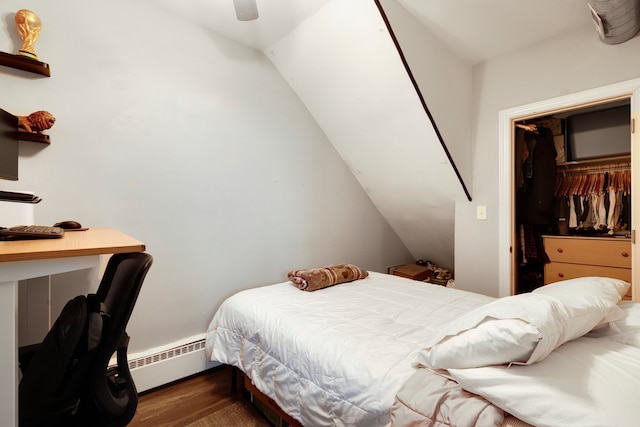 bedroom featuring ceiling fan, lofted ceiling, baseboard heating, and wood finished floors