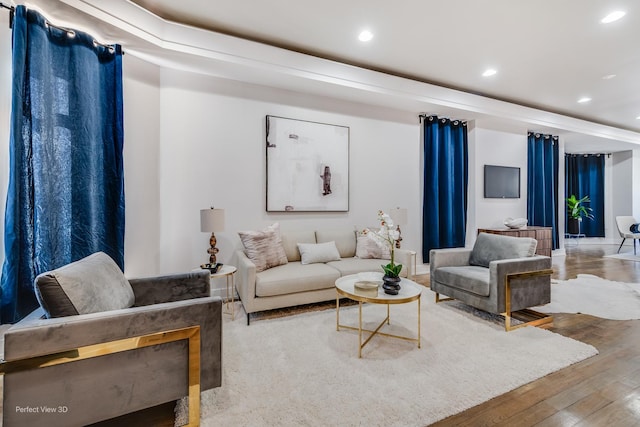 living area with wood finished floors and recessed lighting