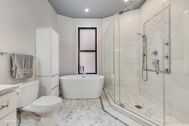 bathroom with a stall shower, a soaking tub, vanity, and toilet