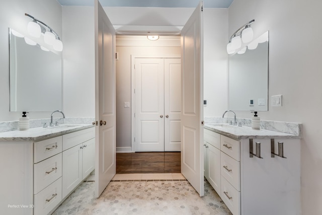 full bath featuring tile patterned flooring, two vanities, and a sink