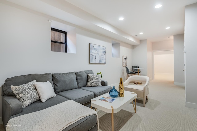 living area with recessed lighting, light colored carpet, and baseboards