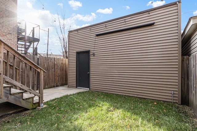 view of outbuilding featuring fence