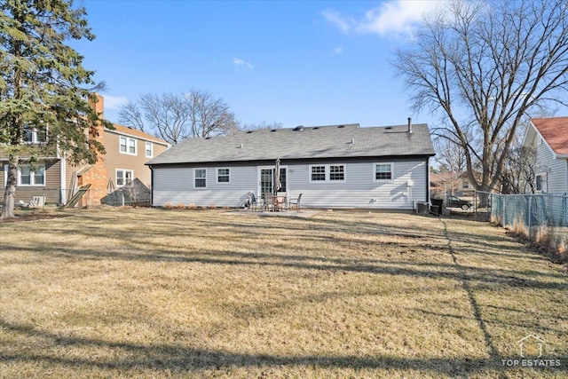 back of house with central air condition unit, a lawn, a patio area, and fence