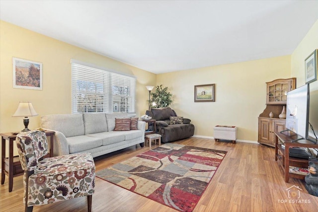 living room featuring light wood-style flooring and baseboards