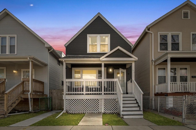 view of front of property featuring covered porch and fence