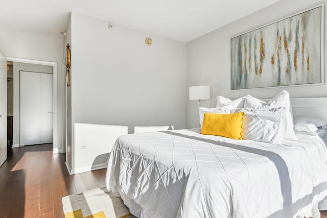 bedroom with wood finished floors and baseboards