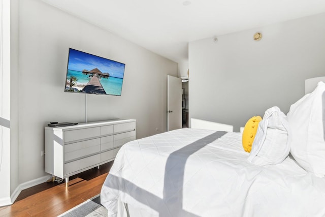 bedroom featuring wood finished floors and baseboards