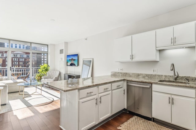 kitchen featuring dishwasher, dark wood-style floors, a peninsula, white cabinetry, and a sink