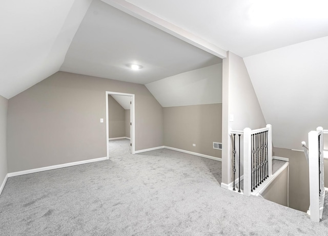 bonus room featuring visible vents, carpet floors, baseboards, and vaulted ceiling