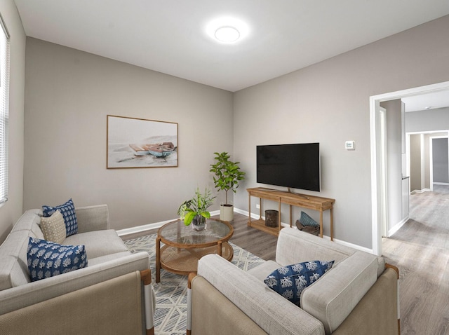 living area with wood finished floors and baseboards