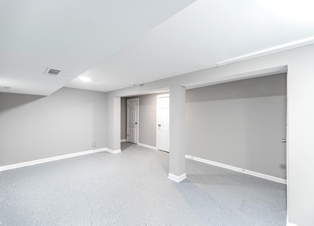 finished basement featuring visible vents and baseboards