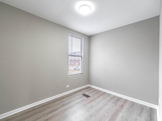 spare room with visible vents, baseboards, and light wood-style flooring