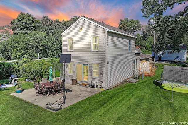 rear view of house with a patio area and a yard