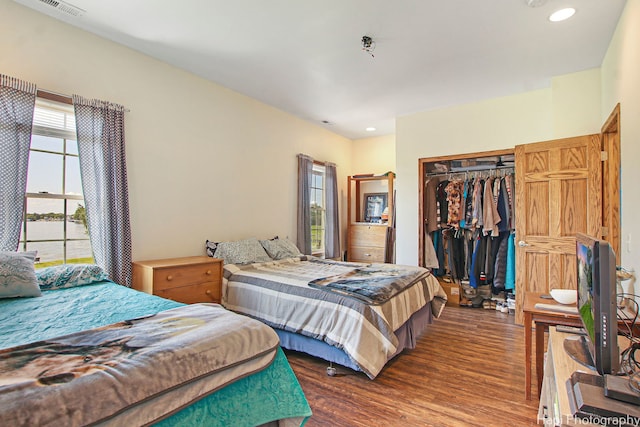 bedroom featuring recessed lighting, a closet, visible vents, and wood finished floors