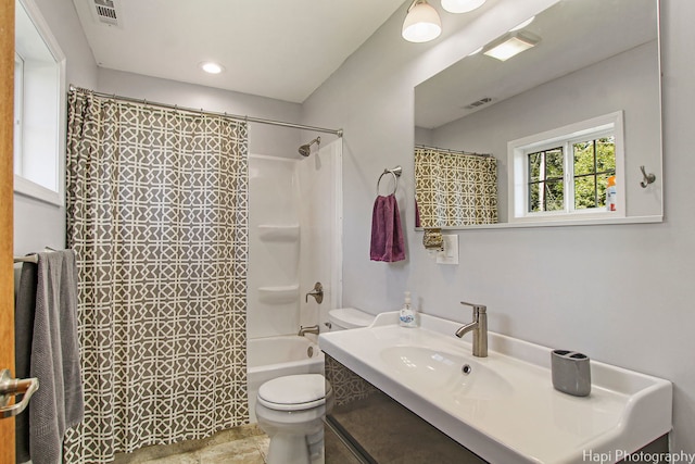 full bathroom with toilet, shower / tub combo, visible vents, and vanity