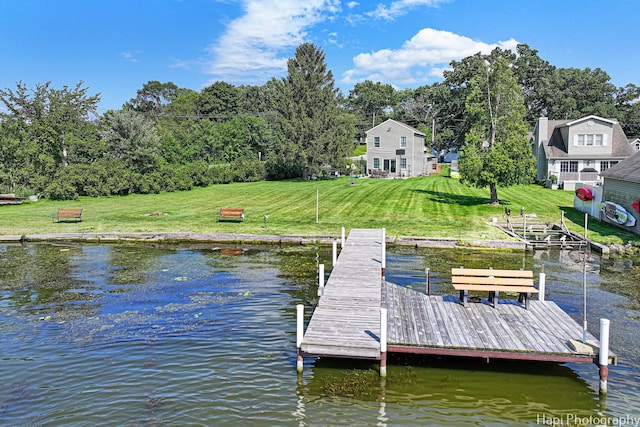 view of dock featuring a water view and a lawn