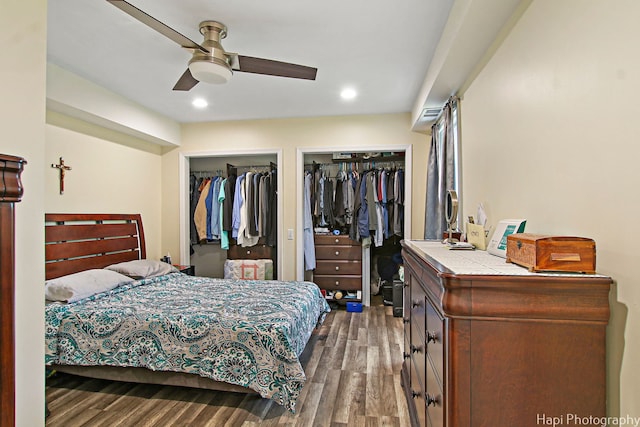 bedroom featuring multiple closets, recessed lighting, dark wood-type flooring, and a ceiling fan