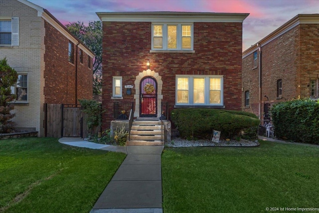 view of front of property with fence, a front lawn, and brick siding