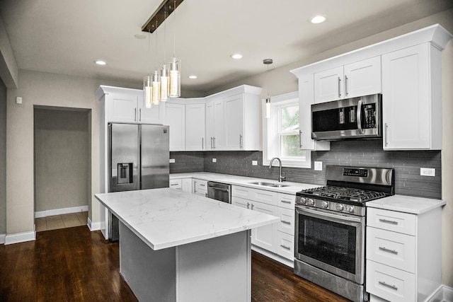 8837 S Throop St, Chicago, IL 60620 - kitchen featuring stainless steel appliances, a sink, a kitchen island, baseboards, and decorative backsplash