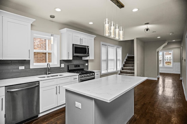 8837 S Throop St, Chicago, IL 60620 - kitchen featuring appliances with stainless steel finishes, a sink, backsplash, dark wood-style floors, and white cabinetry