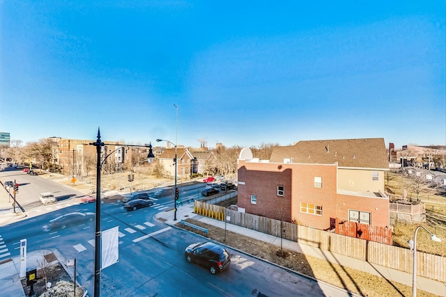 exterior space with curbs, street lighting, sidewalks, and a residential view