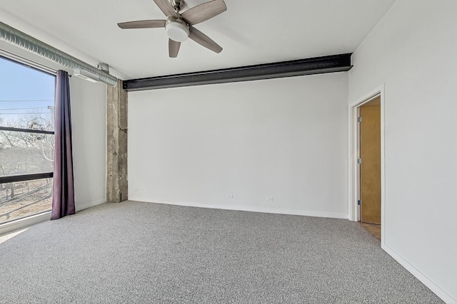 empty room featuring ceiling fan, baseboards, and carpet flooring