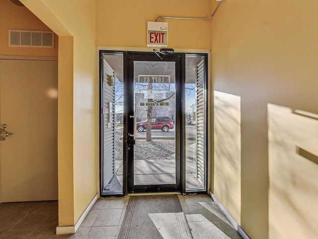 entryway featuring baseboards, visible vents, and tile patterned floors