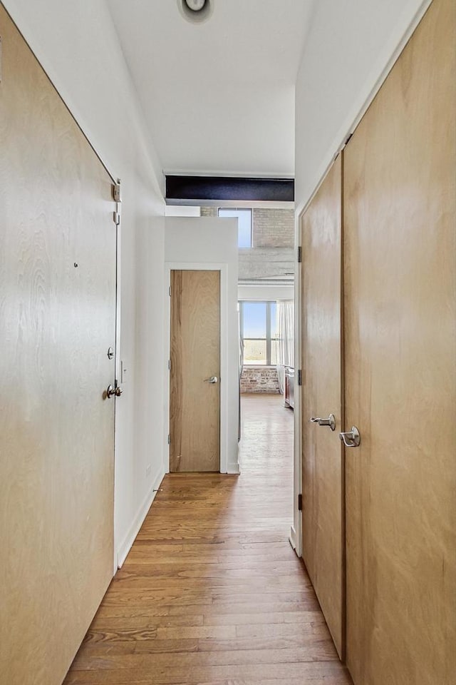 corridor featuring light wood finished floors