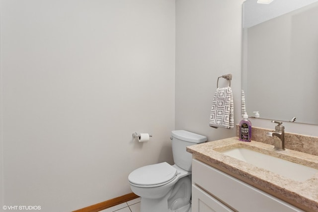 bathroom with tile patterned floors, toilet, vanity, and baseboards