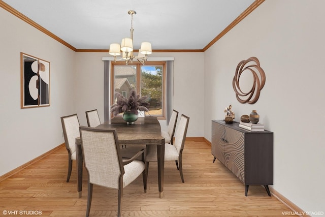 dining room with an inviting chandelier, crown molding, baseboards, and light wood finished floors