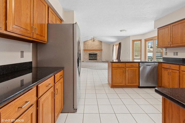 kitchen featuring brown cabinets, appliances with stainless steel finishes, and open floor plan