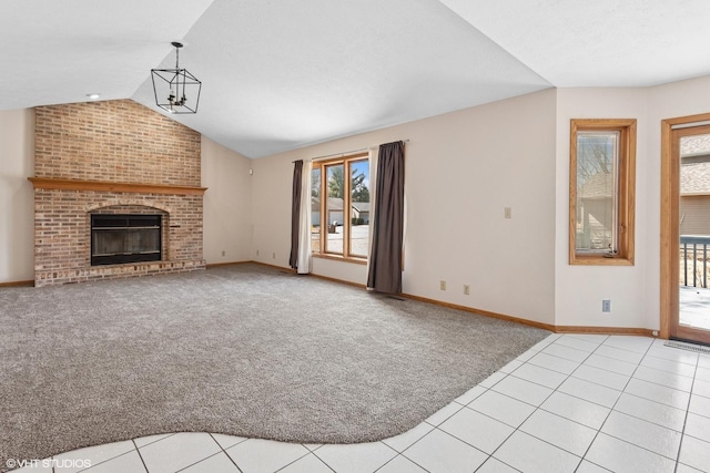 unfurnished living room featuring a brick fireplace, baseboards, light colored carpet, lofted ceiling, and light tile patterned flooring