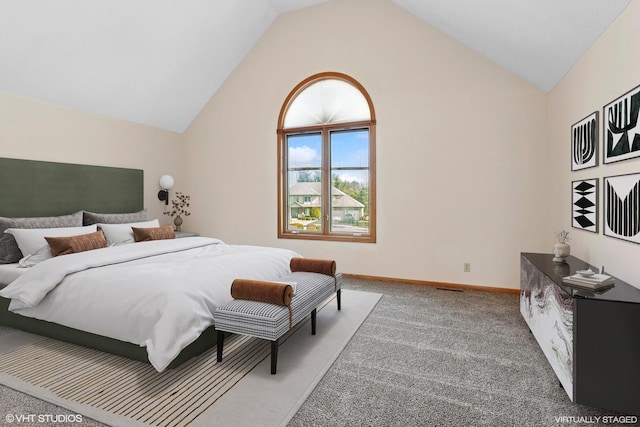 bedroom with lofted ceiling, light colored carpet, and baseboards